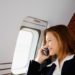 Businesswoman Using Cell Phone on Private Jet. Photo by Sam Churchill. License: CC BY 2.0.